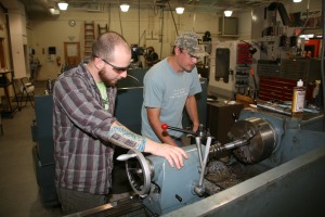 Brian Pierce (left) and Brooks Cain (right) work on a lathe machine in the shop for GNTC’s Machine tool Technology program. Pierce and Cain both served as specialist in the U.S. Army and knew each other before they entered the program.