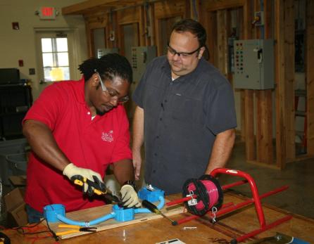 Melvin Mitchell (left), of Cartersville, works with IDEAL tools while Scott Carter (right), director of Electrical System Controls at GNTC, supervises in the electrical lab on the Floyd County Campus. Mitchell was part of the Career Pathways team that won the gold medal in the SkillsUSA Georgia competition and the bronze medal in the national SkillsUSA competition.